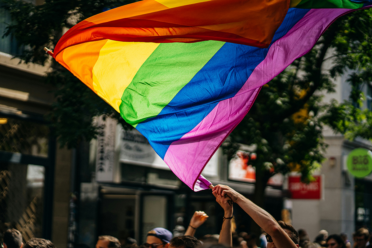 Pride flag being flown at a parade