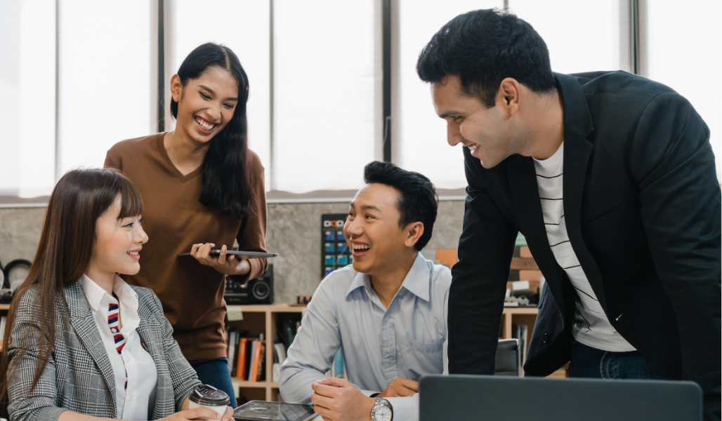 Young Asian American co-workers in a meeting and interacting with each other