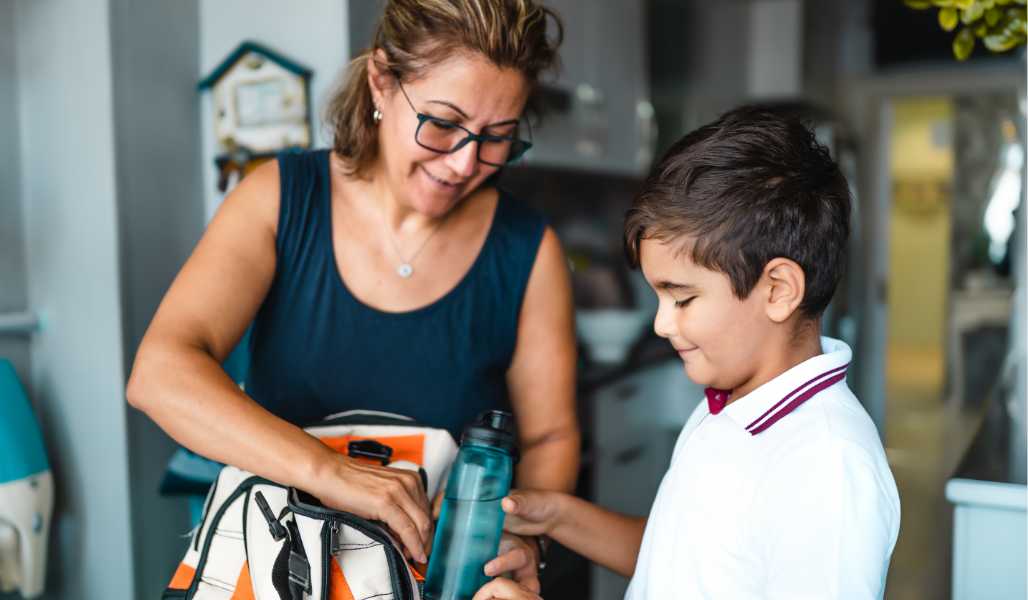 Adult helping child prepare for school