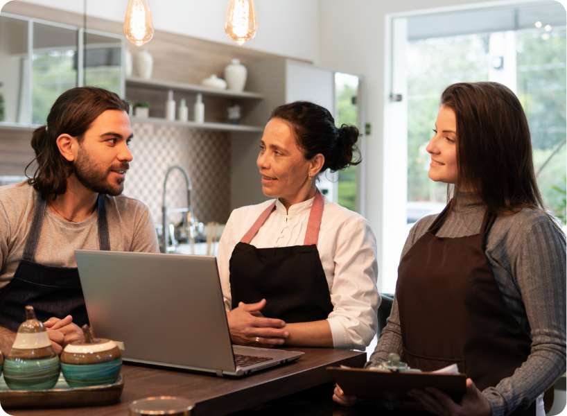 Colleagues of a small business having a discussion in a kitchen