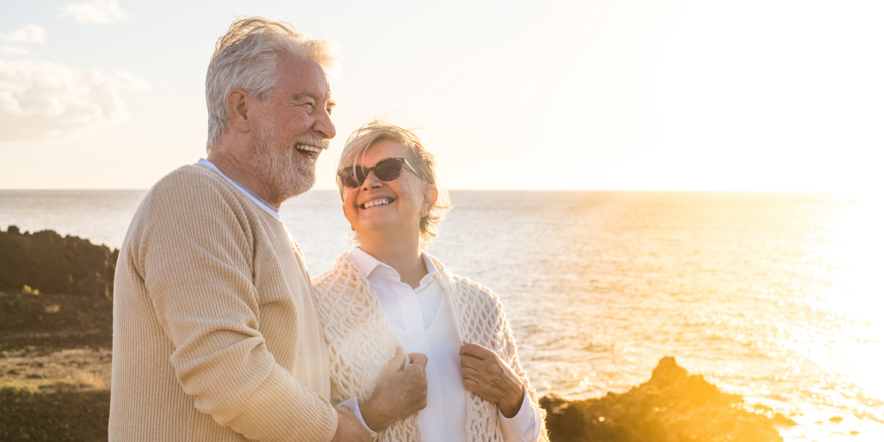 Senior couple by the ocean during sunset