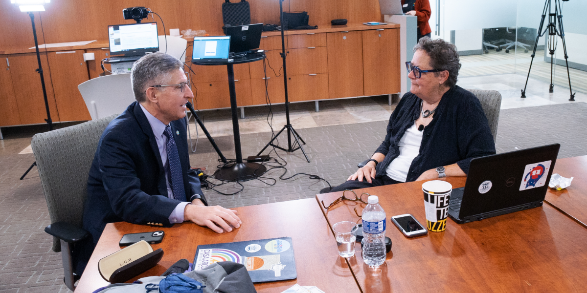 Mark Stuart and Kim Klein speaking with each other between sessions