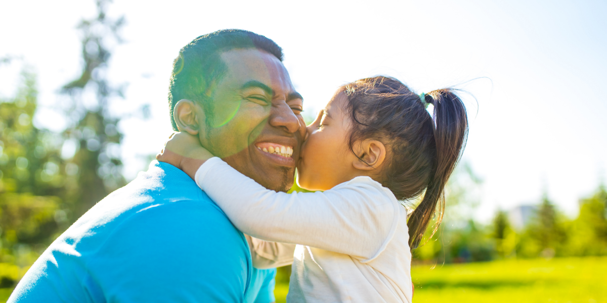 Father and young daughter outside