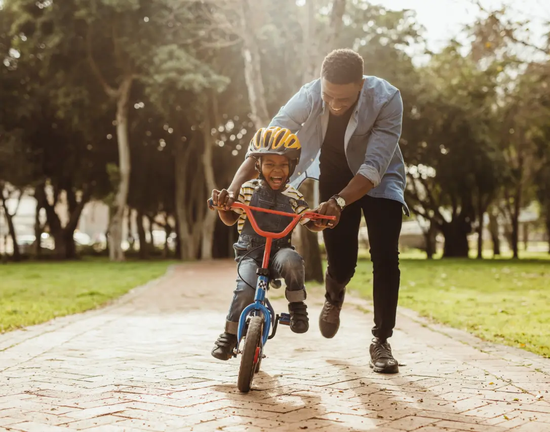 Child Biking With Father