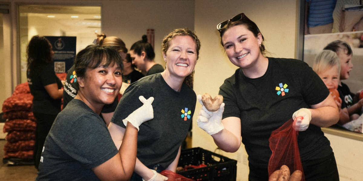 EmmyLynn Pham, Miranda Hyldahl and Sara Ruth posing with a heart-shaped potato at a Feeding San Diego volunteer event