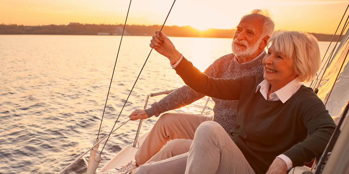 Retired couple enjoy time together on a sailboat