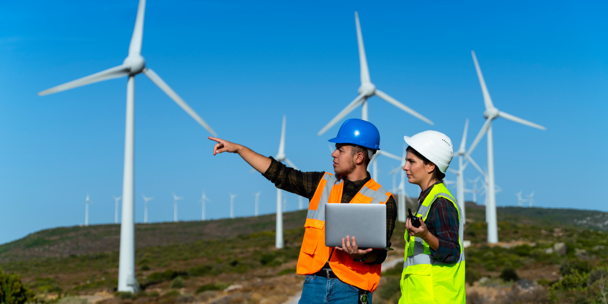 Workers in hard hats with wind turbines