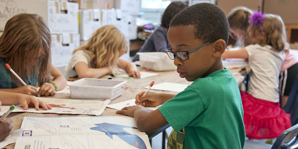 Young student learning in classroom