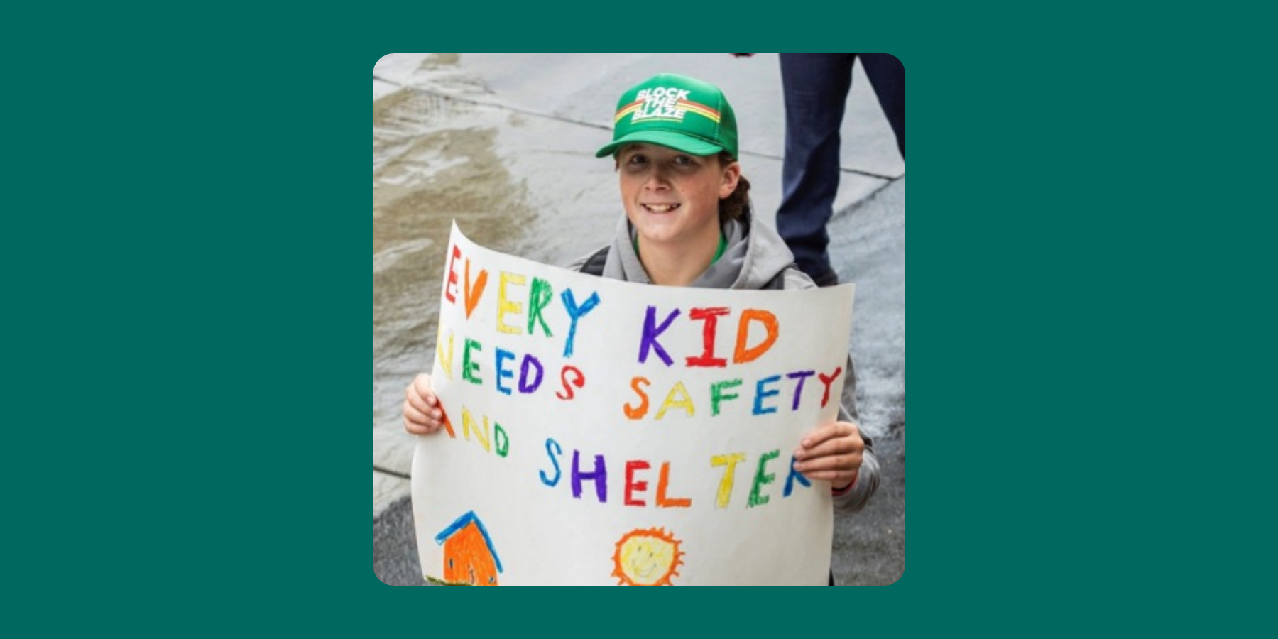 Child holding sign with inspiring message