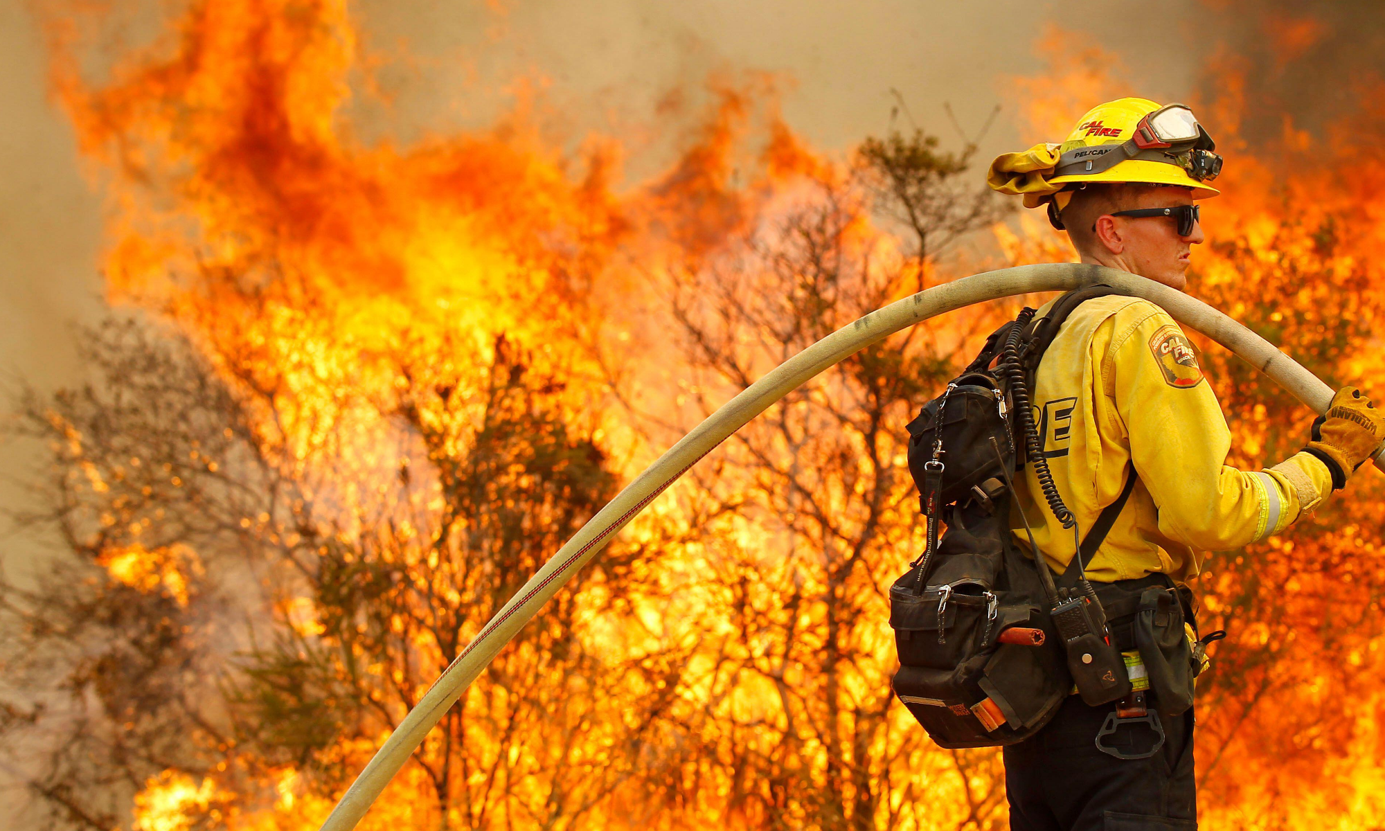 Firefight and wildfire in the background