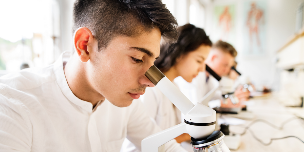 Student looking through microscope