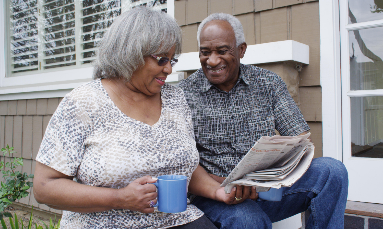 Older adults outside a home